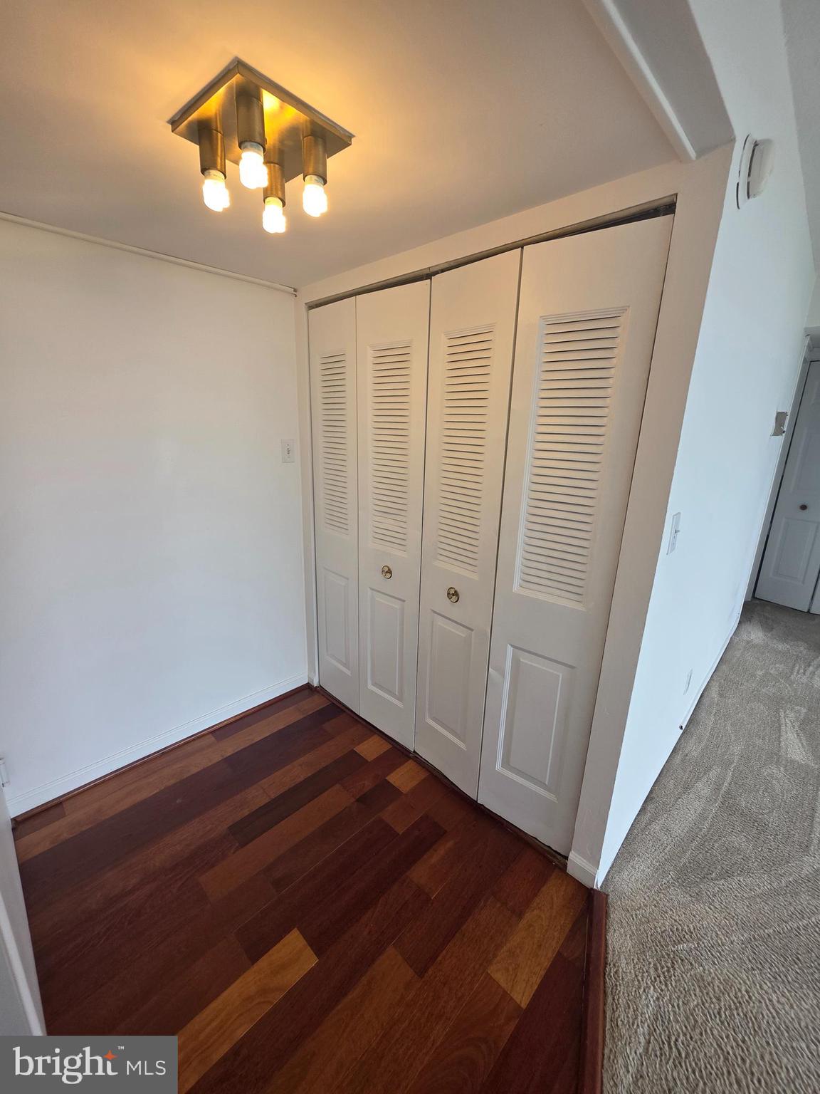 1836 Metzerott Road, Unit 1704 Adelphi, MD 20783 - Photo 44 of 47 en empty room with wooden floor and chandelier fan