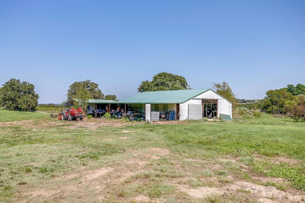 7726 West Highway 199 Springtown, TX 76082 - Photo 23 of 29 a front view of a house with a yard and garage