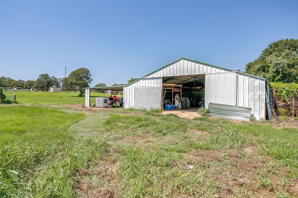 7726 West Highway 199 Springtown, TX 76082 - Photo 24 of 29 a view of a house with a backyard
