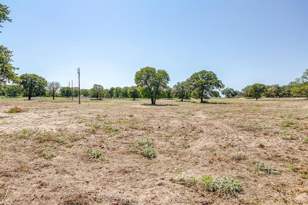 7726 West Highway 199 Springtown, TX 76082 - Photo 26 of 29 a view of a field with some trees in background