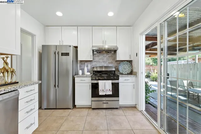 a kitchen with stainless steel appliances granite countertop a stove and a refrigerator