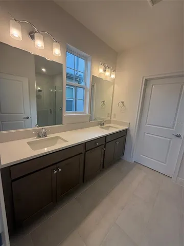 a bathroom with a double vanity sink a and mirror