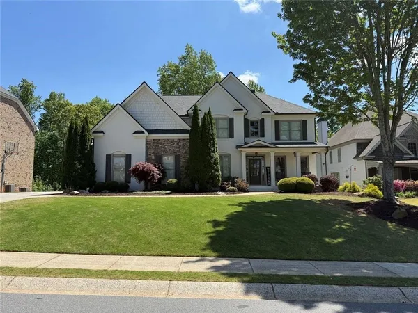 a front view of a house with a yard