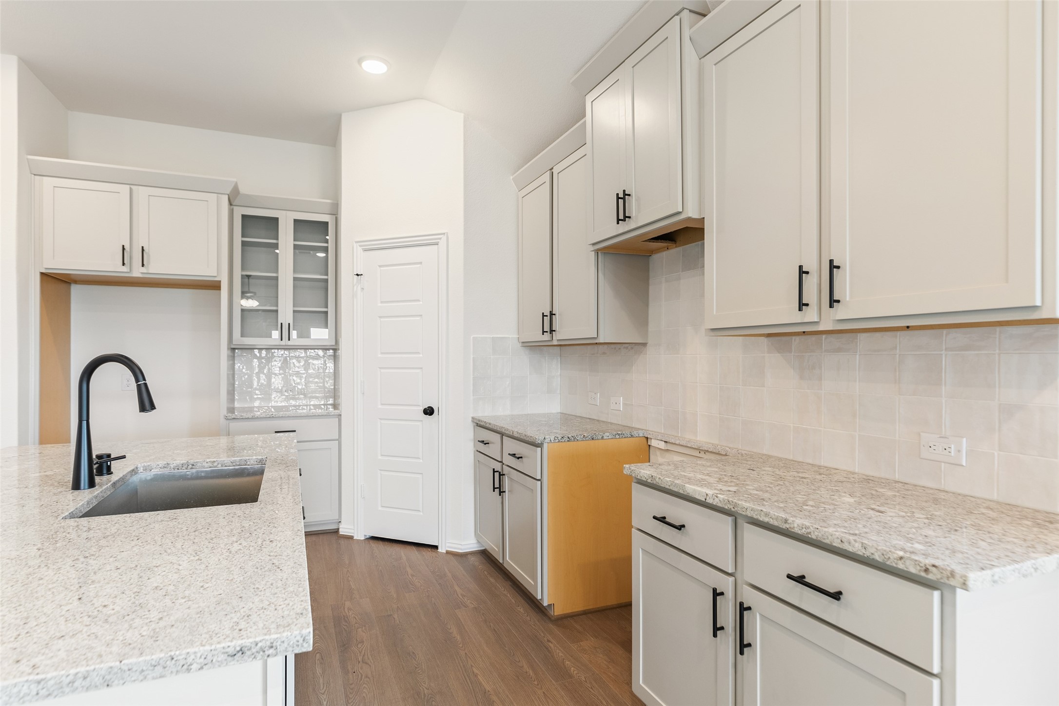 2801 Ruby Laurel Drive Iowa Colony, TX 77583 - Photo 13 of 31 a kitchen with stainless steel appliances granite countertop a sink a stove and cabinets with wooden floor