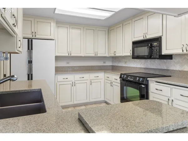 a kitchen with a sink and a refrigerator