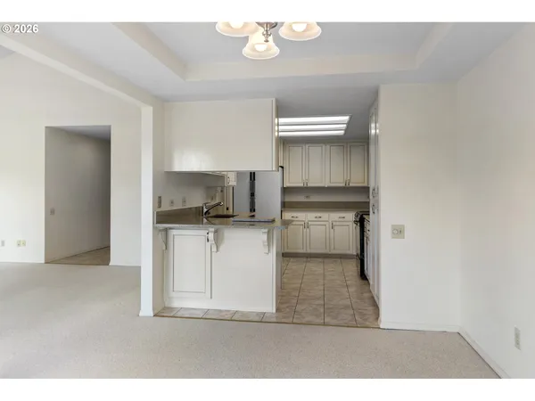 a kitchen with a refrigerator and a stove