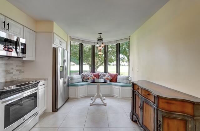 16914 Waterbend Drive, Unit 167 Jupiter, FL 33477 - Photo 11 of 46 a kitchen with stainless steel appliances a stove and a sink