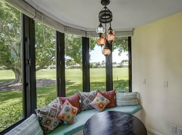 a living room with furniture and a floor to ceiling window