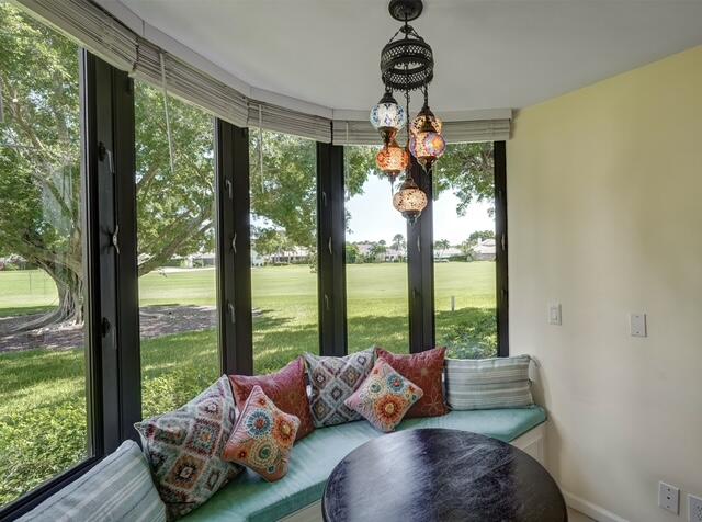 16914 Waterbend Drive, Unit 167 Jupiter, FL 33477 - Photo 13 of 46 a living room with furniture and a floor to ceiling window