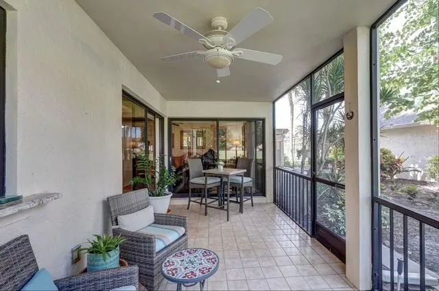 a living room with furniture and a large window with garden view