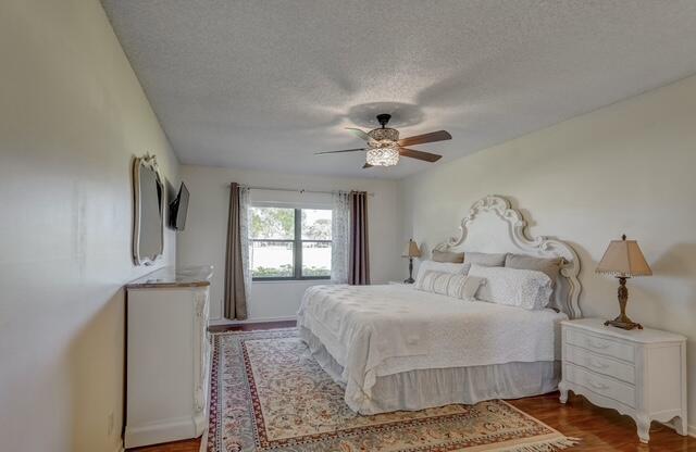 16914 Waterbend Drive, Unit 167 Jupiter, FL 33477 - Photo 17 of 46 a bedroom with a bed and a chandelier