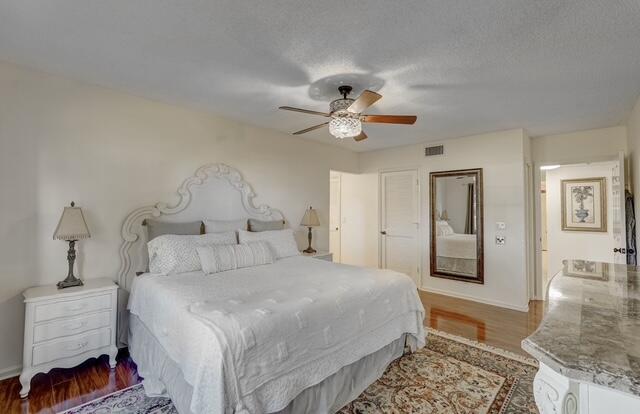 16914 Waterbend Drive, Unit 167 Jupiter, FL 33477 - Photo 19 of 46 a spacious bedroom with a bed and a chandelier