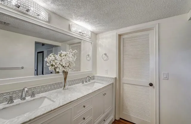a bathroom with a double vanity sink and a mirror