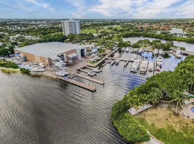 an aerial view of ocean and residential houses with outdoor space
