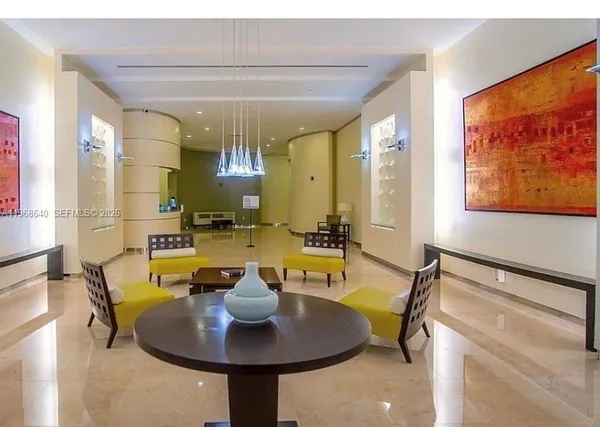 a view of a dining room with furniture and a chandelier