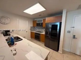 a kitchen with a stove and a refrigerator