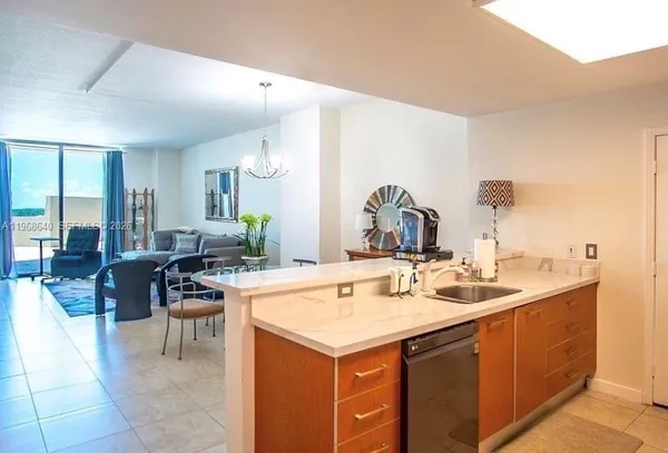 a view of a kitchen counter top space and living room