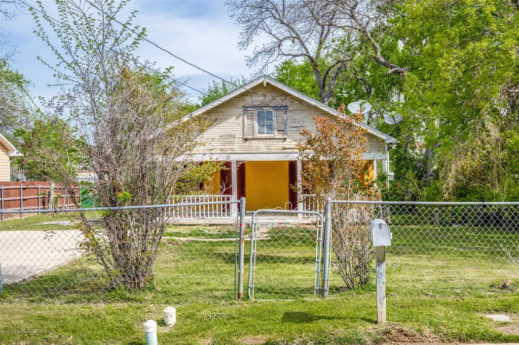 a view of a house with a big yard and a large tree