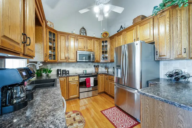 a kitchen with stainless steel appliances granite countertop a stove and a microwave