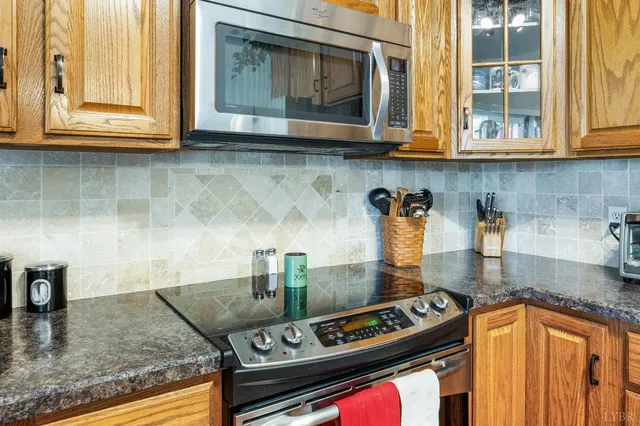 a living room with furniture floor to ceiling window and wooden floor