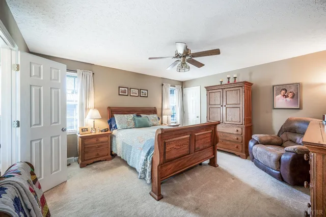 a bedroom with a bed and a table