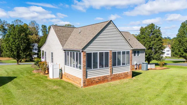 a view of a house with a yard and deck