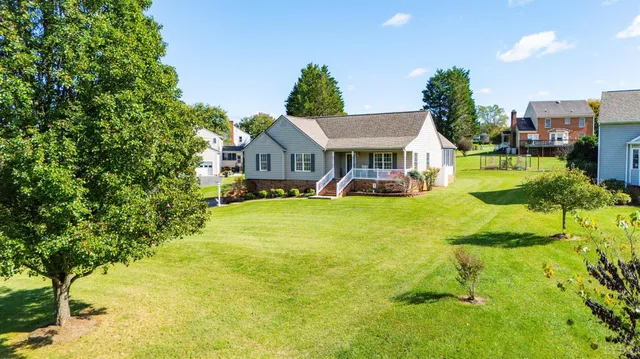 a view of a house with a big yard and potted plants