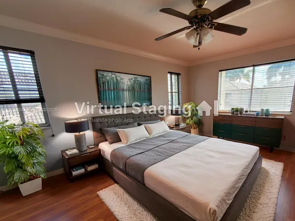 a bed room with a bed and a potted plant