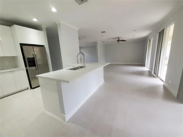 a view of a kitchen with a sink a washer and dryer