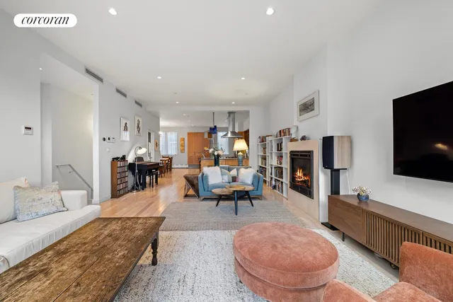 a living room with furniture a rug and a bookshelf