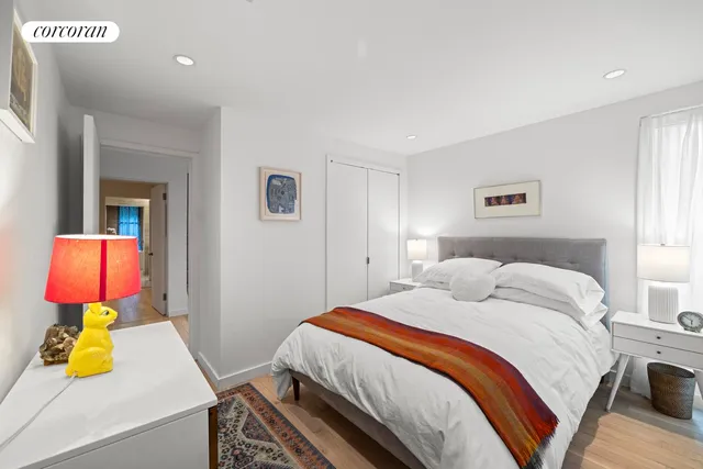 a bedroom with a bed and a couch