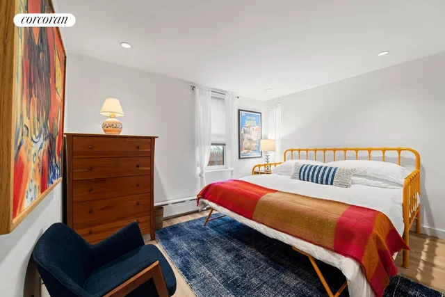 a bedroom with a bed and wall painting