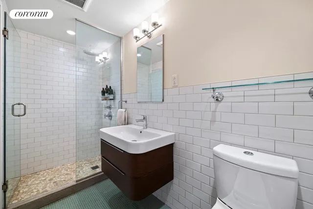 a bedroom with a bed and furniture with a bookshelf