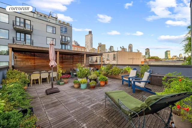 a view of a patio with couches table and chairs with potted plants