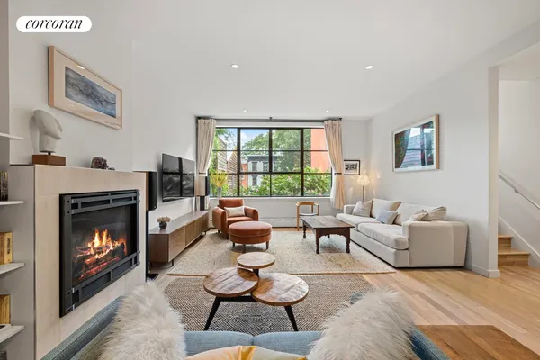 a kitchen with stainless steel appliances granite countertop a sink a stove and a wooden floors