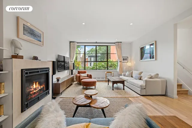 a kitchen with stainless steel appliances granite countertop a sink a stove and a wooden floors