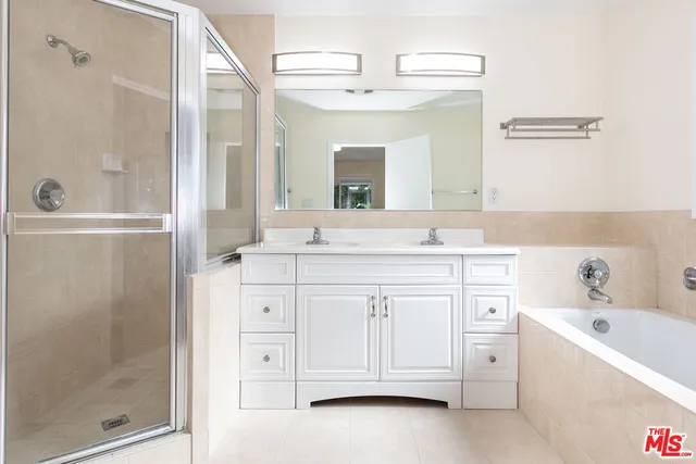 a bathroom with a granite countertop sink a mirror and a bathtub