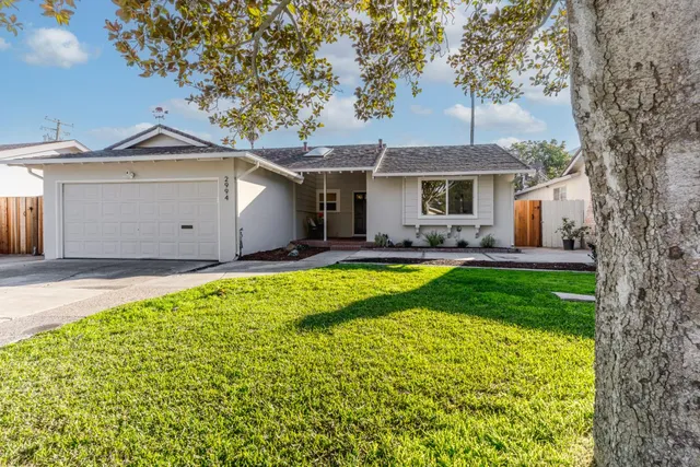 a living room with furniture a fireplace and a clock