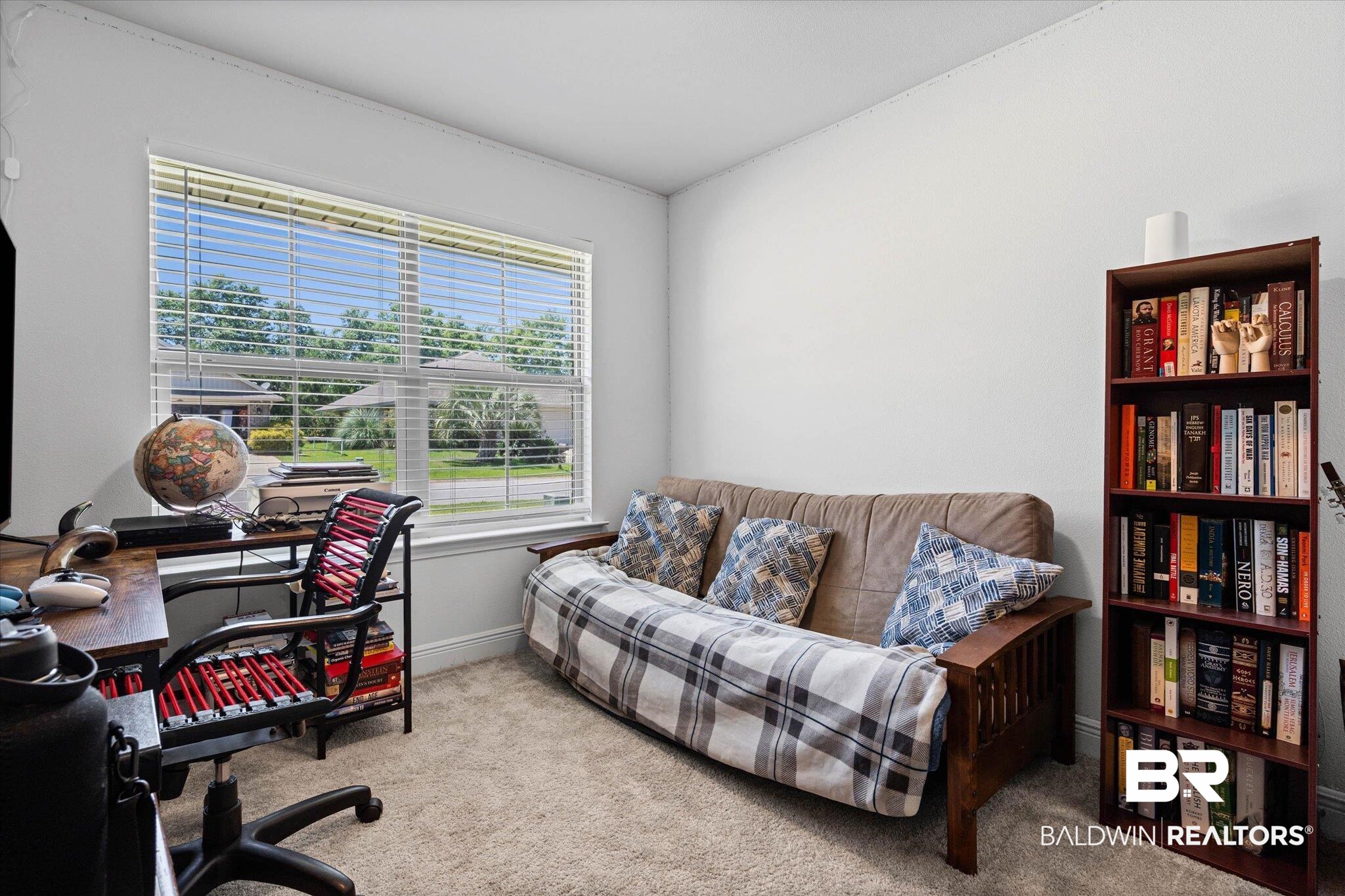 22420 Respite Lane Foley, AL 36535 - Photo 18 of 35 Carpeted room featuring a large window with horizontal blinds, a built-in bookshelf, and light-toned wall finishes