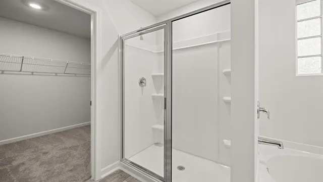 a bathroom with a glass shower door