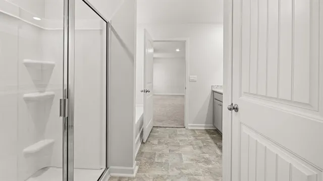a bathroom with a shower and a glass door