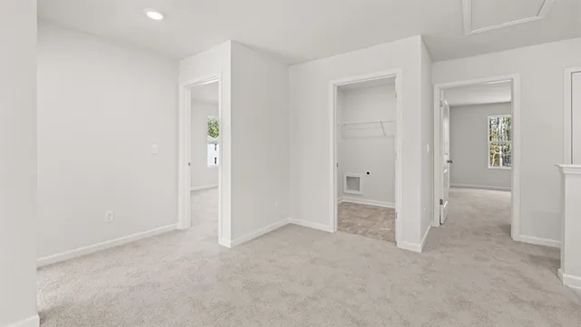 an empty room with closet and mirror