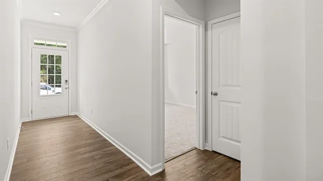 a view of hallway with wooden floor
