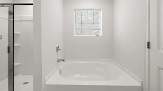 a white bath tub sitting next to a window