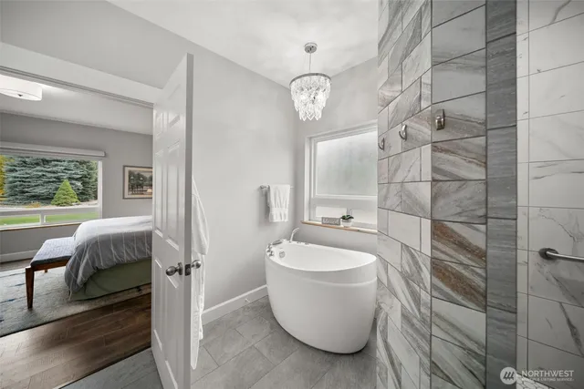 a bathroom with a granite countertop toilet a sink and a mirror
