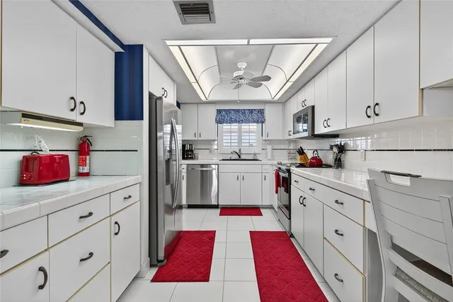 a kitchen with stainless steel appliances granite countertop a stove and a microwave