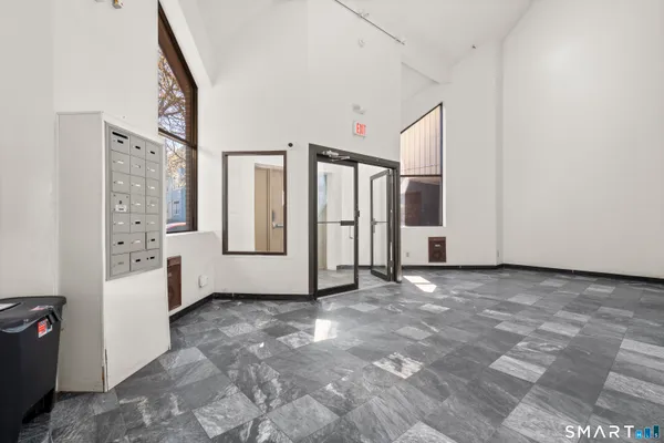 a view of a big room with windows and wardrobe