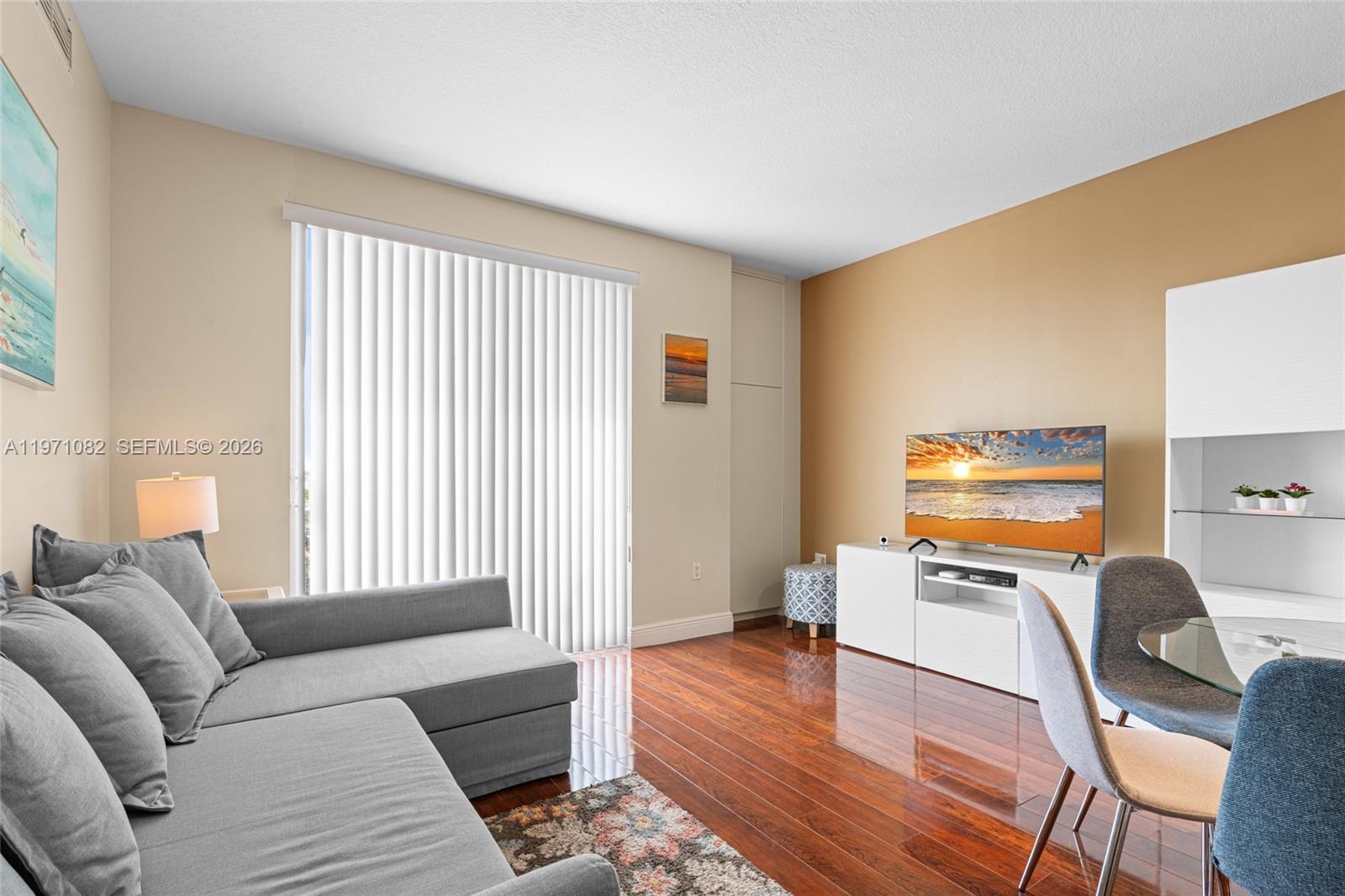 7275 Southwest 90th Way, Unit 404 Miami, FL 33156 - Photo 11 of 35 a living room with furniture and a flat screen tv