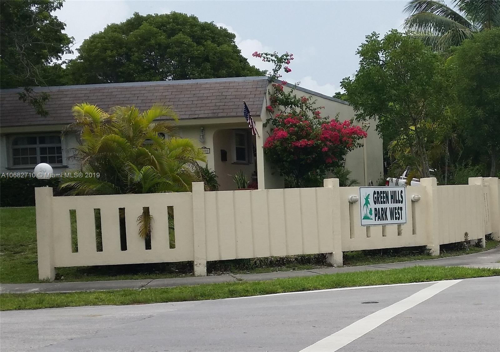 a view of a white house with a yard