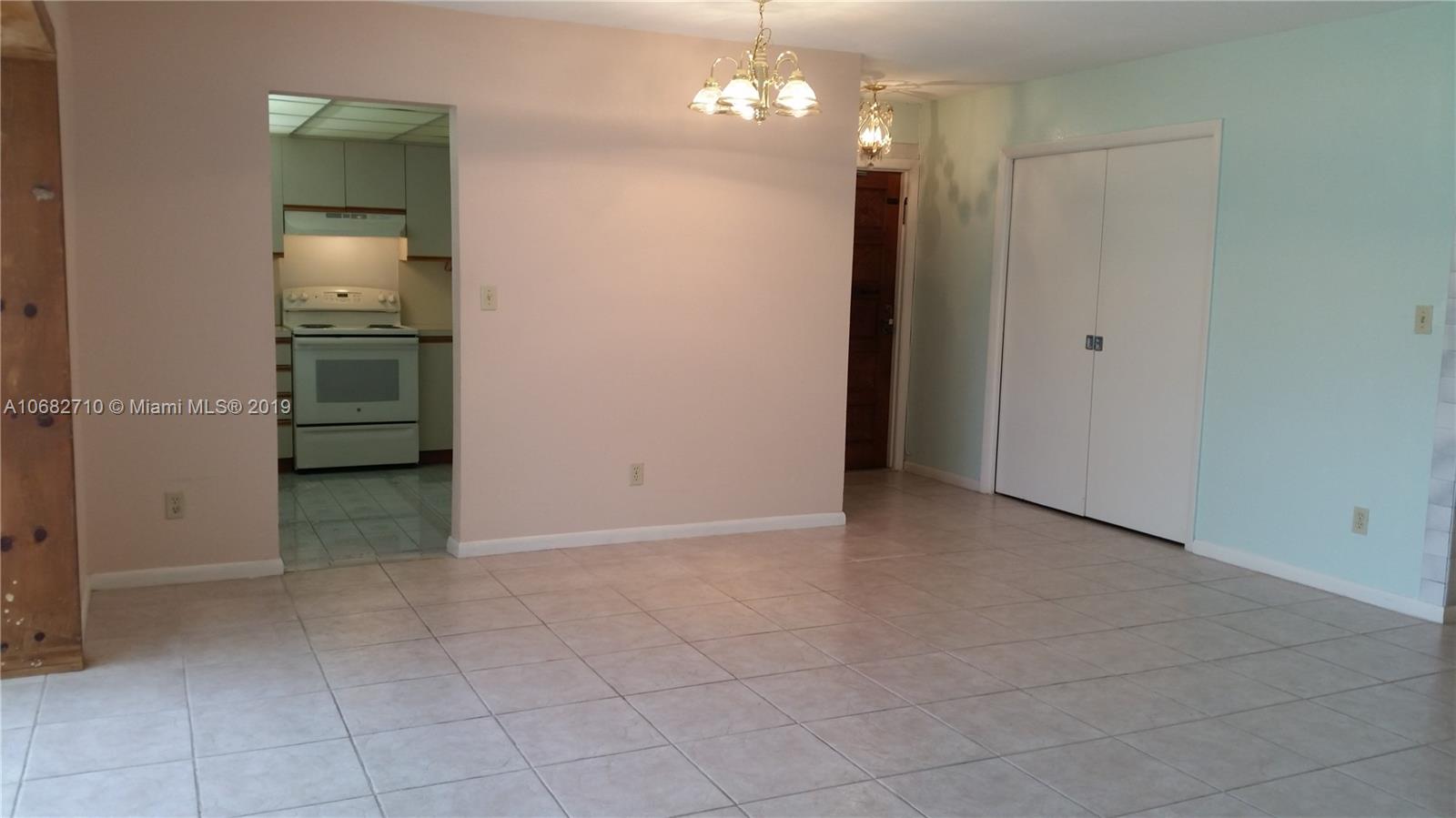 West Perrine Miami, FL 33157 - Photo 4 of 25 an empty room with kitchen chandelier and refrigerator